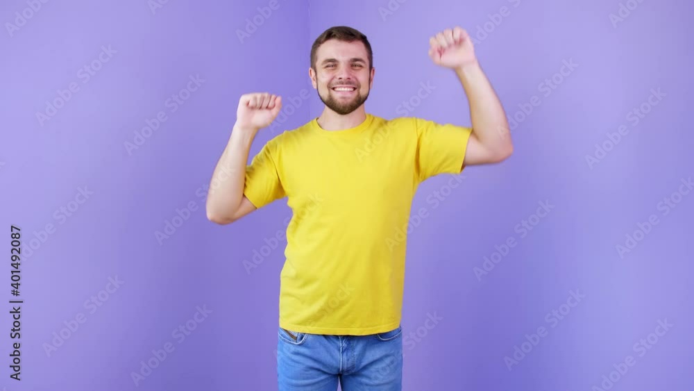 Happy dancing young man on color background Happy dancing young man on color background