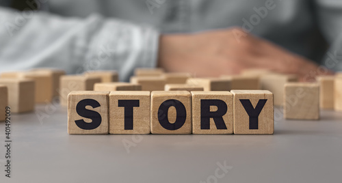 The word STORY made from wooden cubes. Shallow depth of field on the cubes