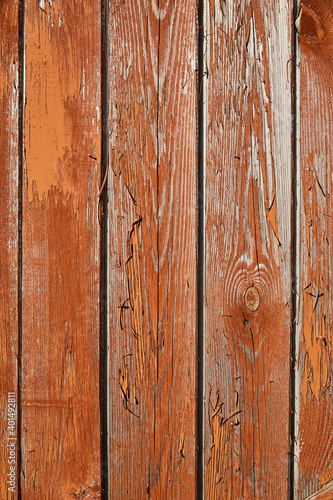 Grunge wooden background with texture, old rough boards with orange-brown peeling and cracked old paint