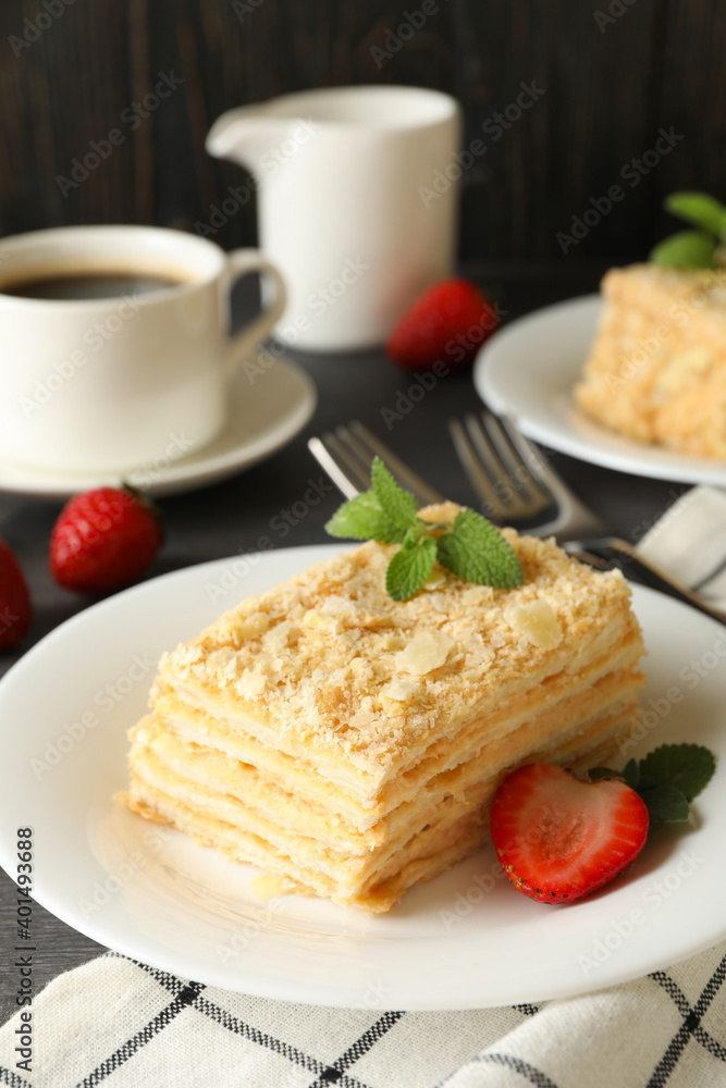 Concept of tasty lunch with Napoleon cake on gray wooden background