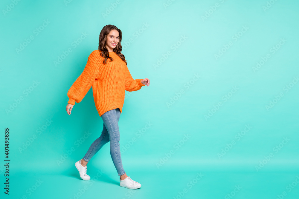 Full body profile side photo of young attractive girl happy positive smile go walk step isolated over turquoise color background Full body profile side photo of young attractive girl happy positive smile go walk step isolated over turquoise color background