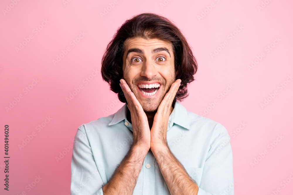 Close up portrait of impressed young man arms on cheeks open mouth unbelievable isolated on pink color background Close up portrait of impressed young man arms on cheeks open mouth unbelievable isolated on pink color background