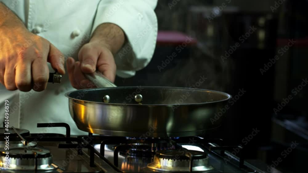 The chef Lights The Fire In The Brazier. Close-Up Food. Cooking Process. Chef Cooking Dish. Chef Preparing Food. (Red Dragon, Cinematic Quality Macro Footage). The chef Lights The Fire In The Brazier. Close-Up Food. Cooking Process. Chef Cooking Dish. Chef Preparing Food. (Red Dragon, Cinematic Quality Macro Footage).