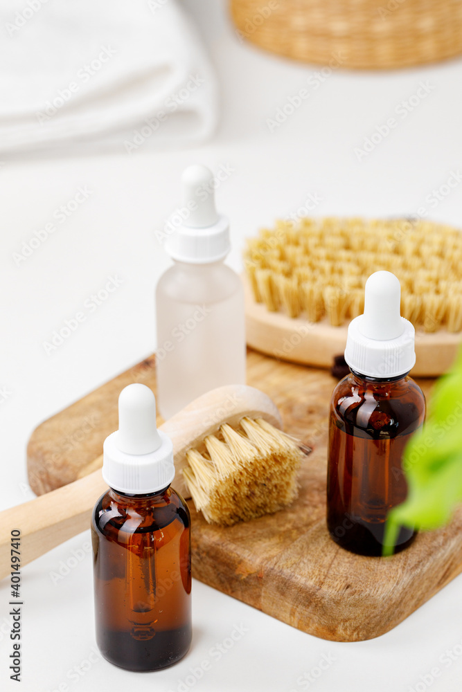 Glass cosmetic oil bottles with pipette in bathroom Glass cosmetic oil bottles with pipette in bathroom
