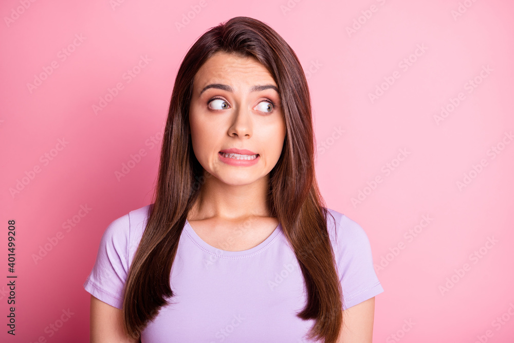 Photo portrait of clumsy girl isolated on pastel pink colored background Photo portrait of clumsy girl isolated on pastel pink colored background