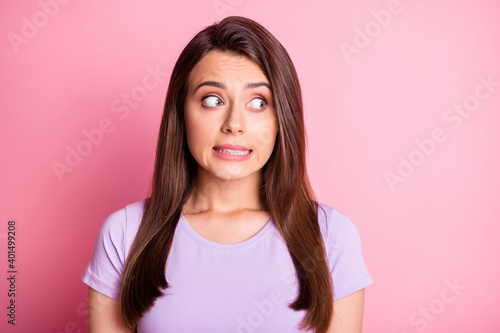 Photo portrait of clumsy girl isolated on pastel pink colored background photo