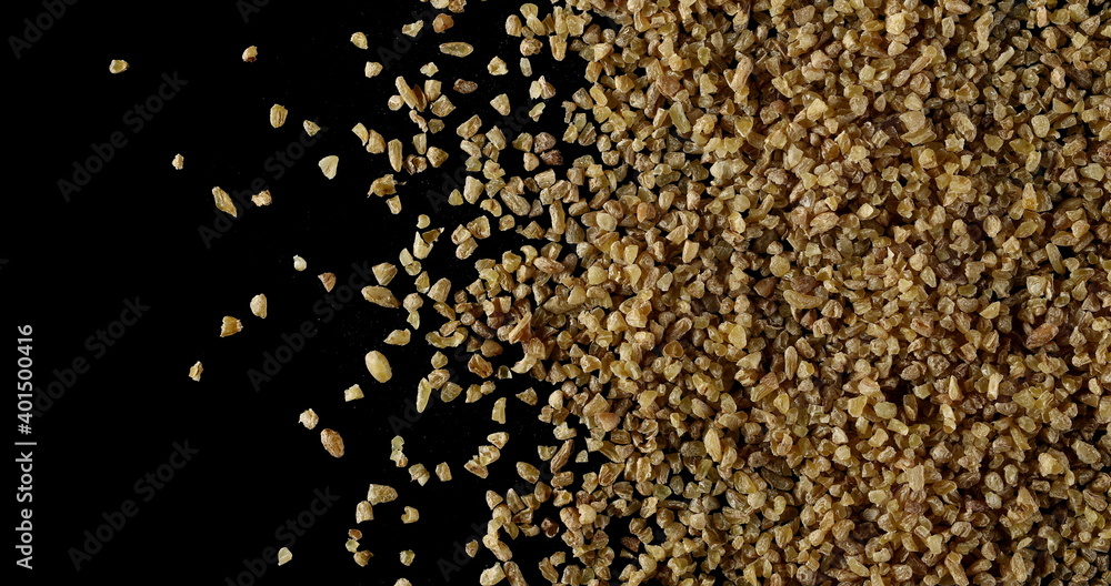 Dry bulgur pile isolated on black background, top view Dry bulgur pile isolated on black background, top view