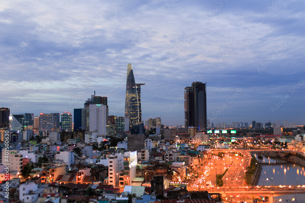 Obraz premium Beautiful night city, cityscape of Ho Chi Minh city, Vietnam, modern futuristic architecture nighttime illumination, luxury traveling concept.