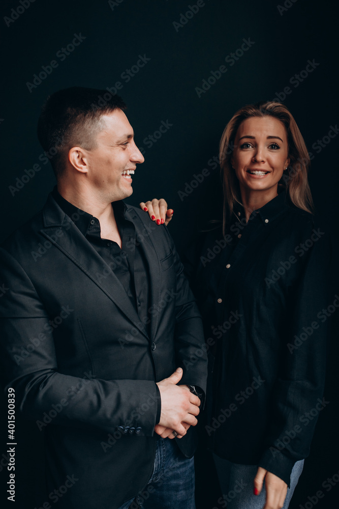 Photoshoot of a young couple in love. The solitude of a guy and a girl. Studio photography. Black background. Photoshoot of a young couple in love. The solitude of a guy and a girl. Studio photography. Black background.