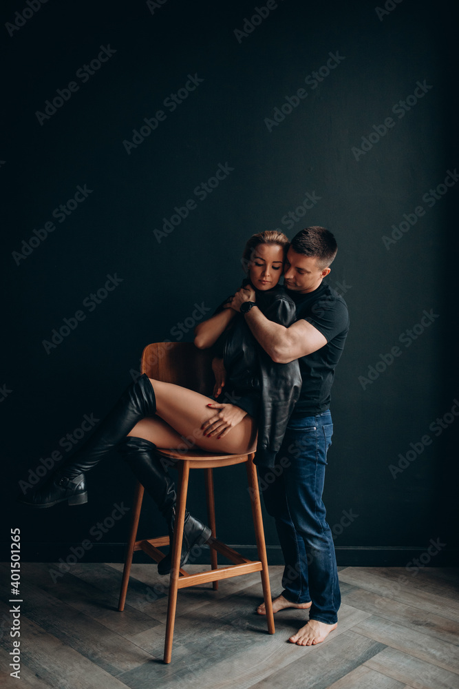Photoshoot of a young couple in love. The solitude of a guy and a girl. Studio photography. Black background. Photoshoot of a young couple in love. The solitude of a guy and a girl. Studio photography. Black background.