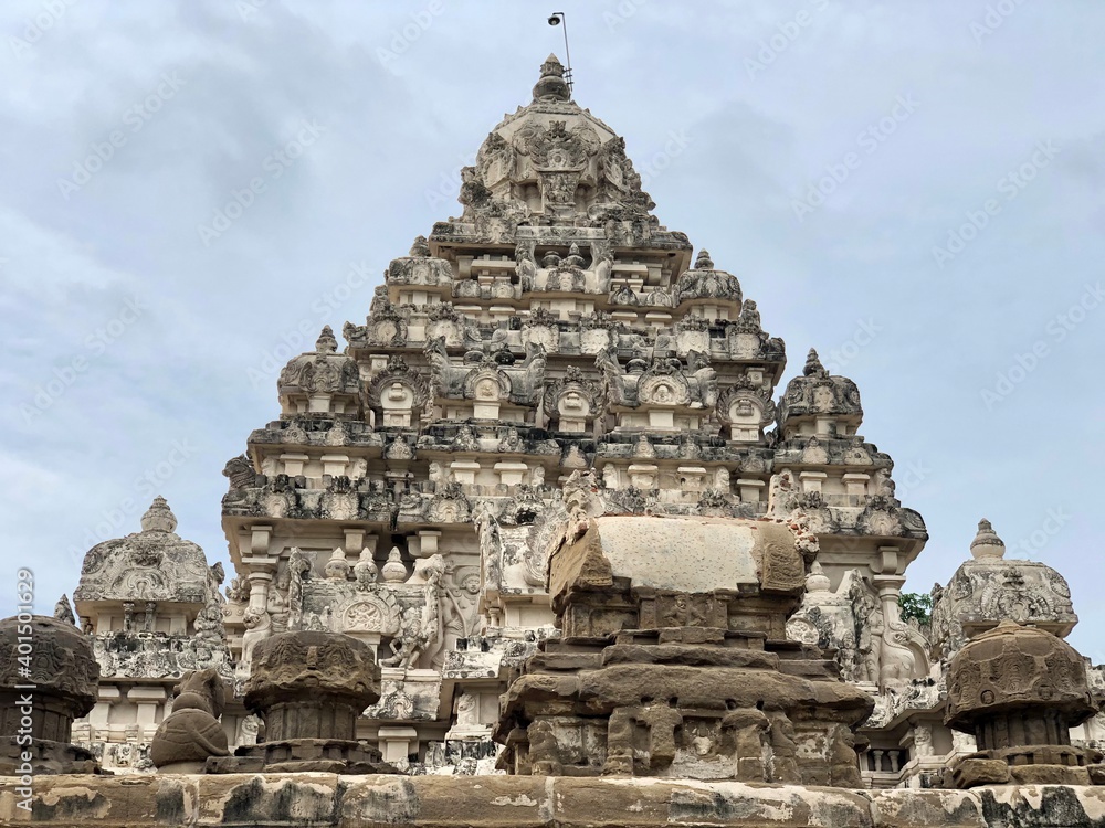 Temple tower against blue sky background. Ancient Hindu temple with sandstone carved historical Hindu God and animal sculptures.