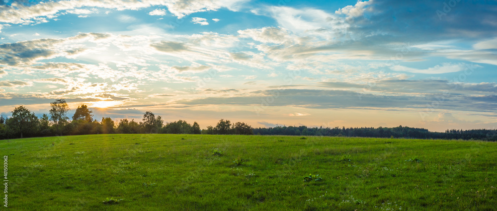 Landscape panorama. Sky with clouds. Green meadow. Gorgeous rural scene. Large open space. - obrazy, fototapety, plakaty 