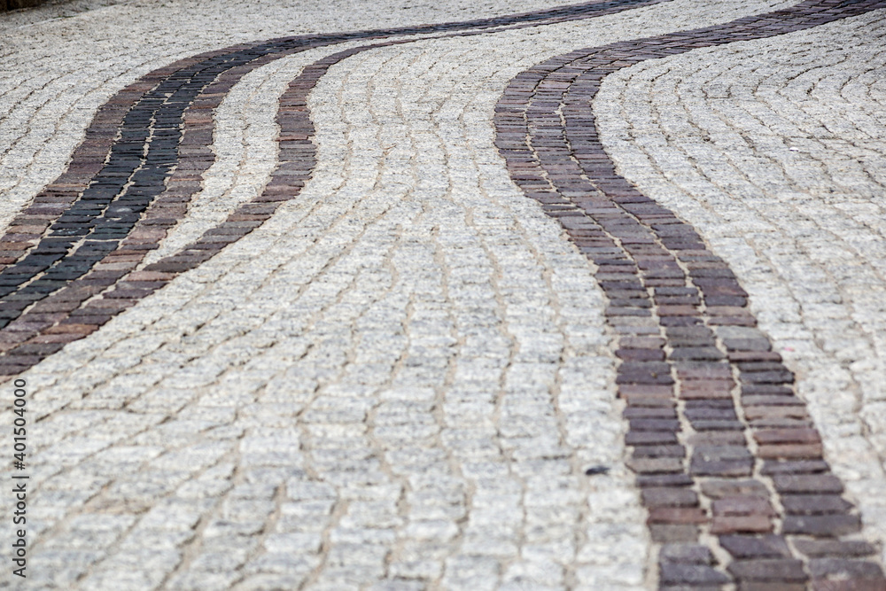Background image of old cobblestone road backlit with low sunlight. Stone texture close up. Small pebbles on the road. Stone path Background image of old cobblestone road backlit with low sunlight. Stone texture close up. Small pebbles on the road. Stone path