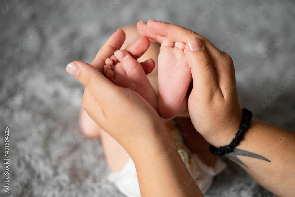 Baby feet in mother hands. Tiny Newborn Baby's feet on female Shaped hands closeup. Mom and her Child. Happy Family concept. Beautiful conceptual image of Maternity Baby feet in mother hands. Tiny Newborn Baby's feet on female Shaped hands closeup. Mom and her Child. Happy Family concept. Beautiful conceptual image of Maternity