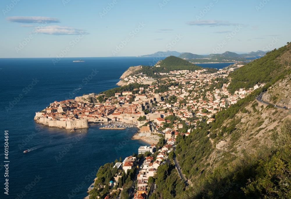 It is a landscape overlooking the walls of Dubrovnik, Croatia. The sky is blue and the blue of the Adriatic Sea is also shining.