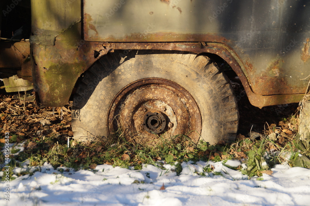 an old wheel from an old truck, covered in mud