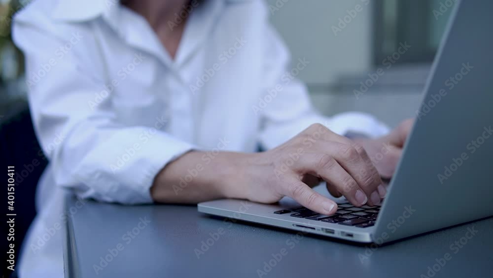 Close up woman in white shirt typing keyboard, female writer working on laptop Close up woman in white shirt typing keyboard, female writer working on laptop