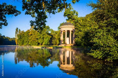 Pavillion reflection at sunrise in a park in Munich, Bavaria, Germany