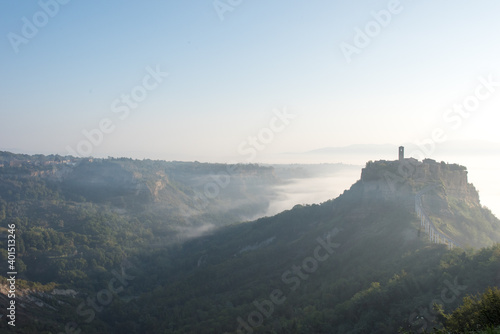 It is a village of Civita di Bagnoregio in Lazio, Italy. Surrounded by the sea of clouds in the morning, it is a fantastic landscape.