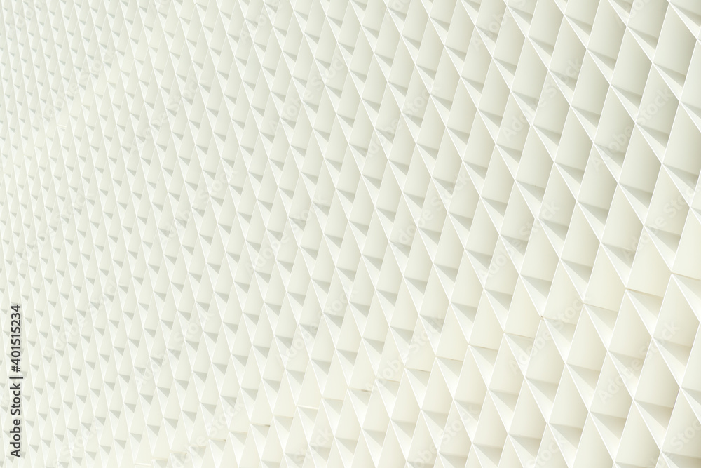 Fototapeta premium A white geometric architectural pattern. A wall of a modern building made of crossed thin metal planks painted in white color