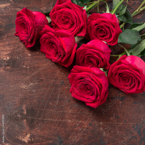 Red rose flowers bouquet on wooden background Valentine s day concept. Square. Copy space. Top view