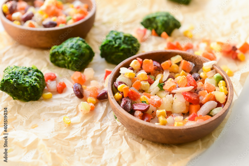 Frozen vegetables in bowl on light background Frozen vegetables in bowl on light background