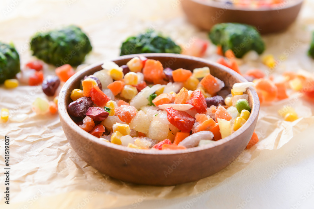 Frozen vegetables in bowl on light background Frozen vegetables in bowl on light background