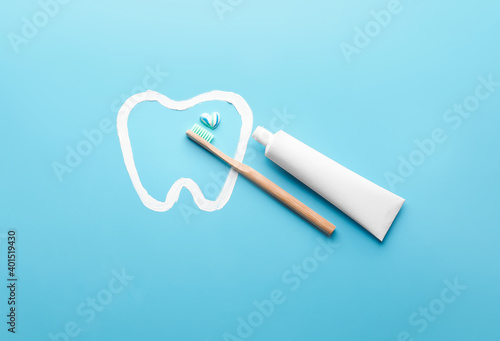 Toothbrush and paste on color background