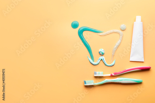 Composition with toothbrushes and paste on color background