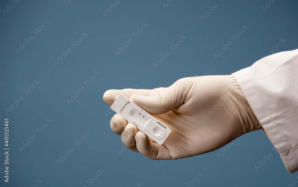 Doctor holding a test kit for viral disease tests with the COVID-19 SARS-CoV-2 laboratory card kit for the novel viral coronavirus sars cov 2 virus (formerly known as 2019-nCov) Doctor holding a test kit for viral disease tests with the COVID-19 SARS-CoV-2 laboratory card kit for the novel viral coronavirus sars cov 2 virus (formerly known as 2019-nCov)