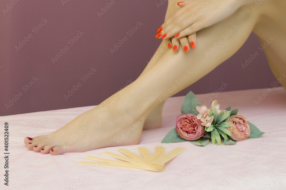 Beautiful well-groomed female legs. Foot care. Depilation of hair on the legs.