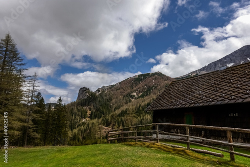 house with a wooden fence in the mountains while hiking