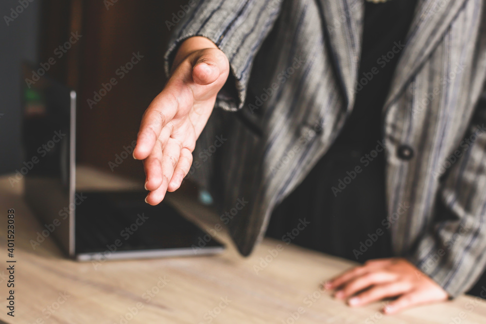 Business woman standing and gives hand for handshake proposes partnership, successful business, greeting 