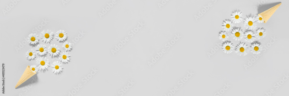 Bouquet chamomile flowers in waffle ice cream cone on gray color background. Trendy colors 2021. Copy space Flat lay Top view Concept Hello summer Banner Bouquet chamomile flowers in waffle ice cream cone on gray color background. Trendy colors 2021. Copy space Flat lay Top view Concept Hello summer Banner