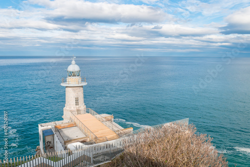 lighthouse on the edge of a hill