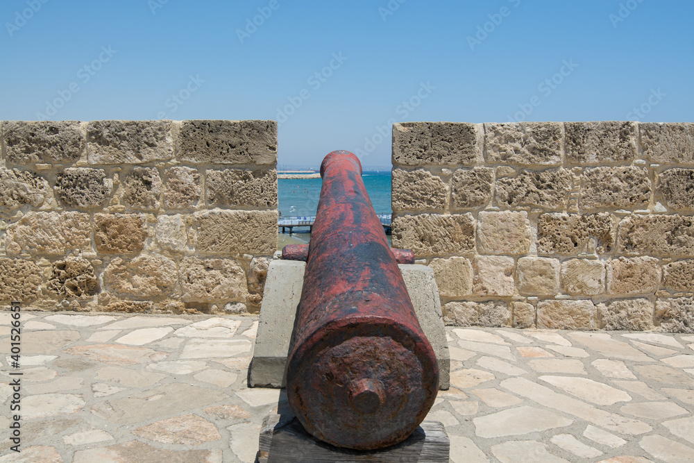 Cannons on the stone wall of  Medieval Castle  and blue sea
