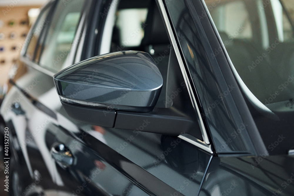 View from side. Close up focused view of brand new modern black automobile