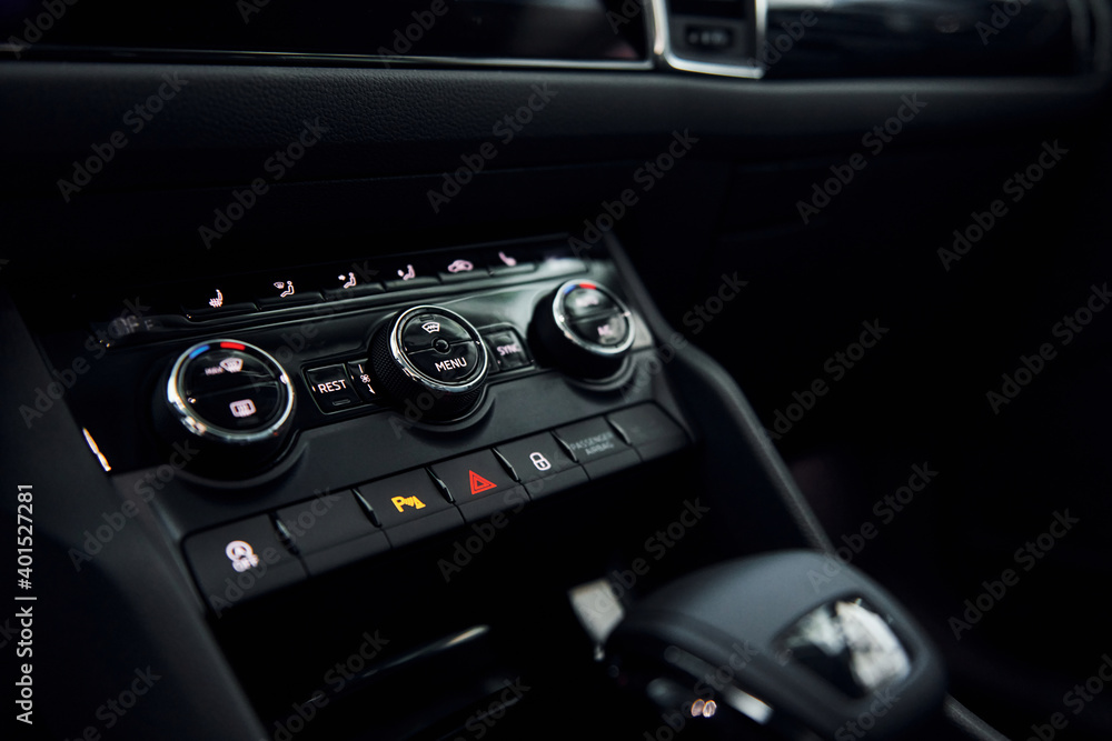 Knobs and buttons. Close up focused view of brand new modern black automobile