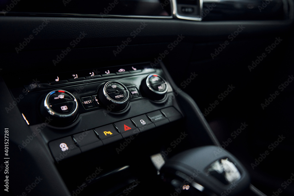Knobs and buttons. Close up focused view of brand new modern black automobile Knobs and buttons. Close up focused view of brand new modern black automobile