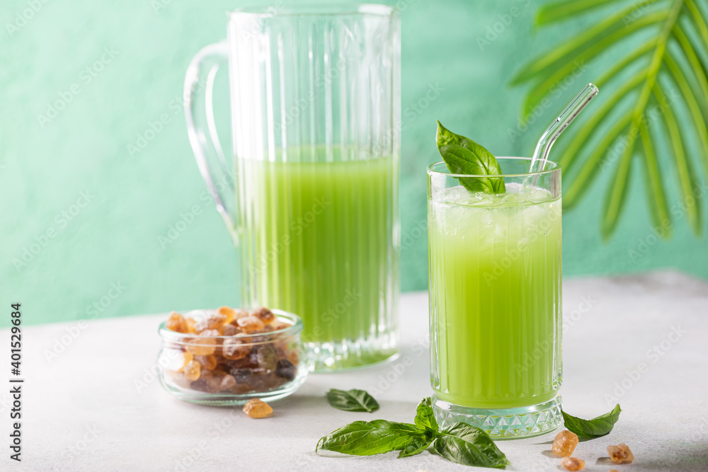 Cold basil lemonade refreshing summer drink on gray background Cold basil lemonade refreshing summer drink on gray background