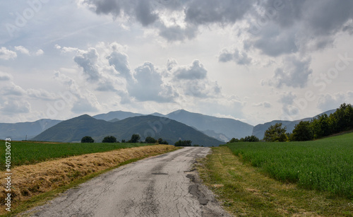 Rural private road through a small pass in the mountains of Urbino, Italy