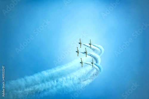 Airplanes on airshow. Aerobatic team performs flight at air show