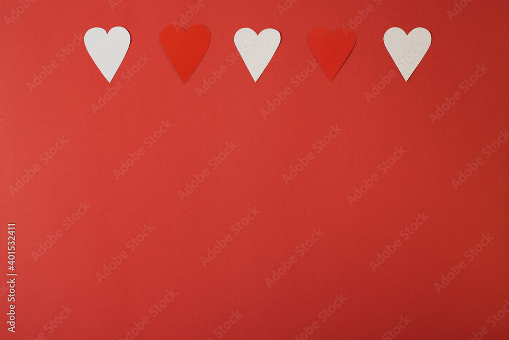 Paper hearts over the red background. Abstract background with paper cut shapes. Saint Valentine, mother's day, birthday greeting cards, invitation, celebration concept