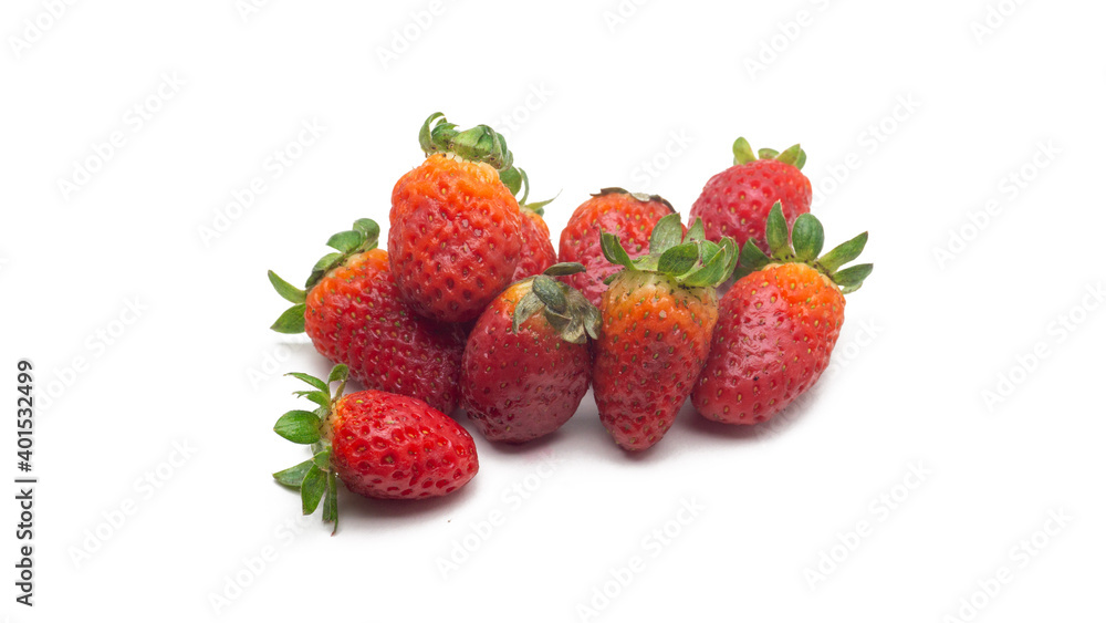 Close up view a group of fresh red strawberries with leaves on isolated white background. Close up view a group of fresh red strawberries with leaves on isolated white background.