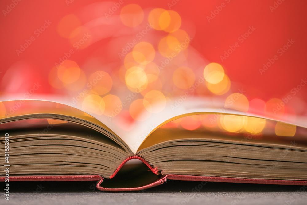 Book with lights on red background. Romantic Valentine concept Book with lights on red background. Romantic Valentine concept