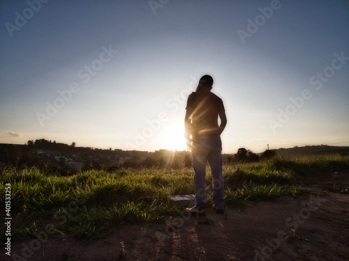 person walking in the sunset © Rodrigo Kampos