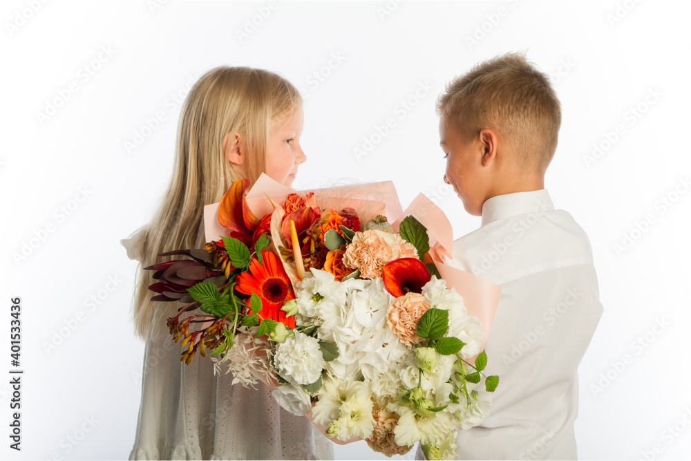 Studio portrait boy gives girl festive bouquet, congratulatory concept, white background, copy space Studio portrait boy gives girl festive bouquet, congratulatory concept, white background, copy space