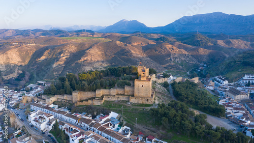 Typical Spanish castle on a hill seen from aerial drone view in Andalusian city of Antequera, south Spain
