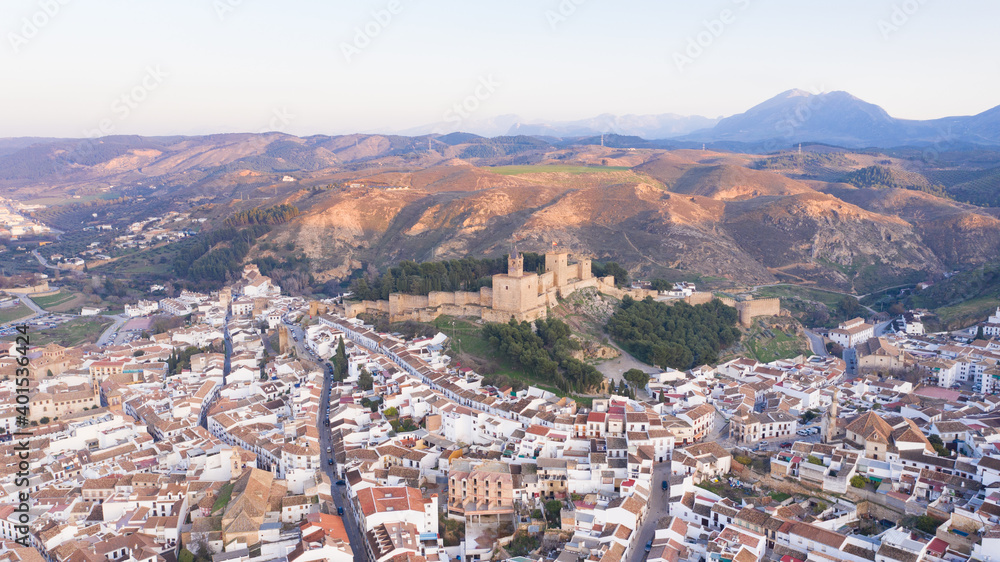 Typical medieval Spanish castle on top of a hill with town sorrounding. Antequera city seen from above aerial view