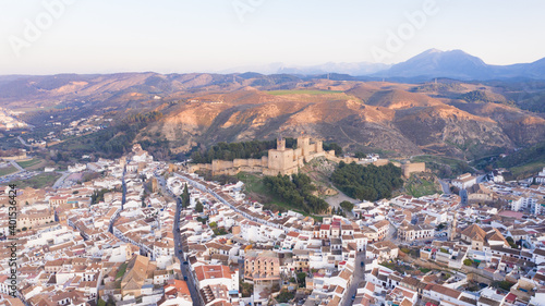 Typical medieval Spanish castle on top of a hill with town sorrounding. Antequera city seen from above aerial view
